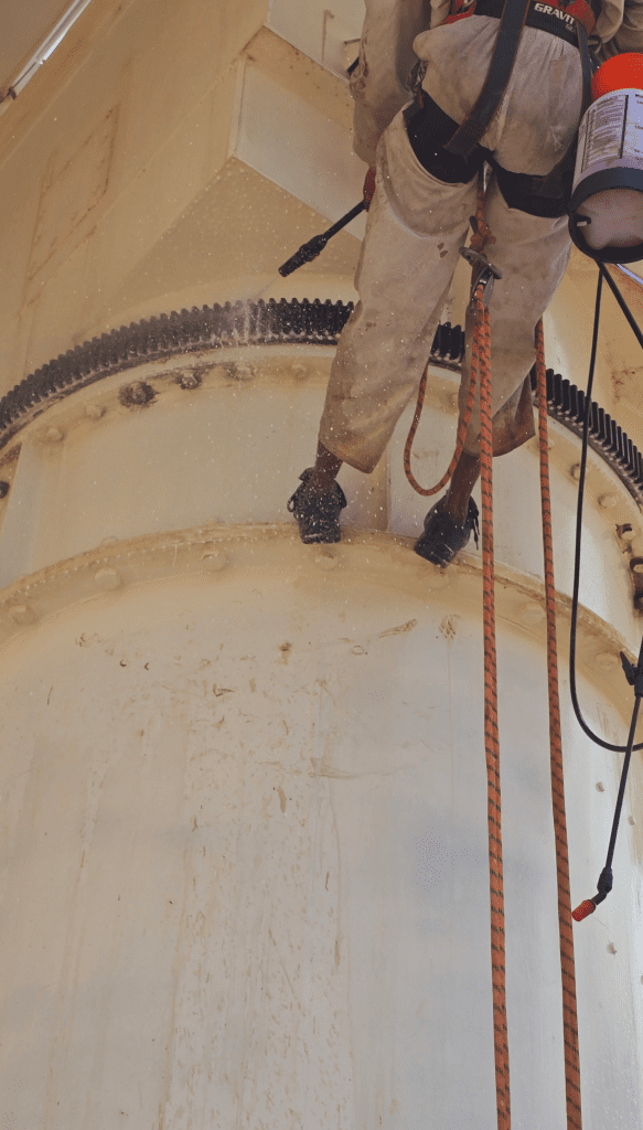 Satellite PPM Maintenance Hartebeespoort technician applying rust treatment during rope access maintenance