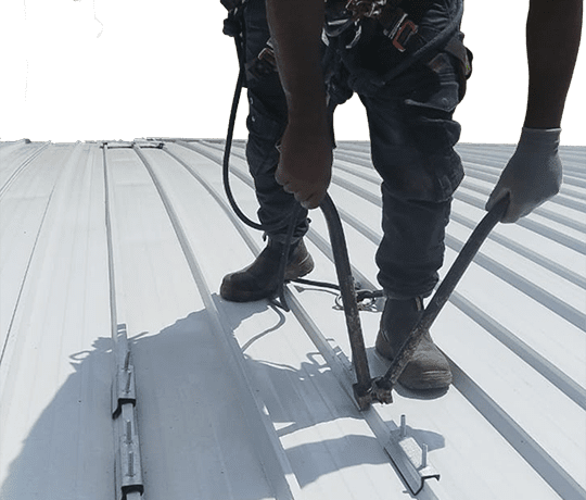 Cut out of Rope access technician installing a permanent horizontal lifeline system during roof safety installation at St Charles College in Pietermaritzburg.