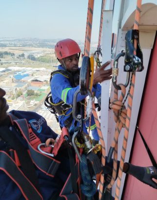 Rope Access Signage Repair Johannesburg with technicians working together on the ABSA Tower sign