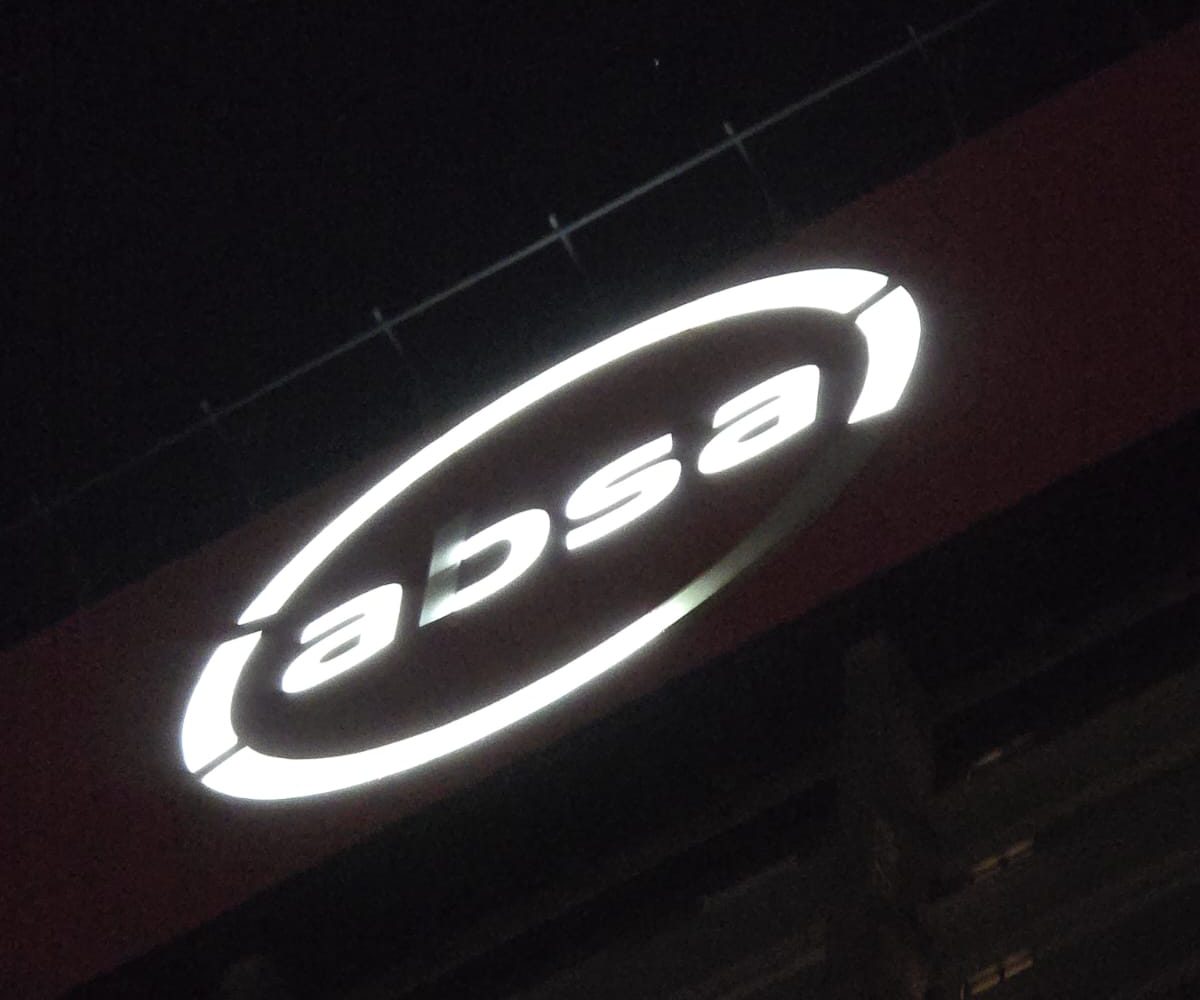 Rope Access Signage Repair Johannesburg showing dim ABSA Tower LED signage before repair