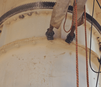 Satellite PPM Maintenance Hartebeespoort technician applying rust treatment during rope access maintenance