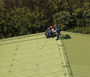 metal roof lifeline installation work near roof ridge at CNG Holdings